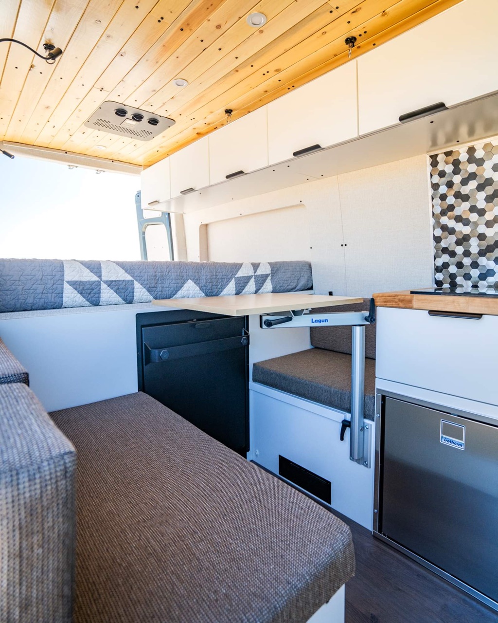 The bench seating and storage inside the van.
